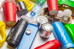 Varios tipos de envases y residuos, como latas, botellas de plástico, envases de cartón y bolsas, ilustrando la diversidad de materiales regulados por el Reglamento de envases y residuos de envases 2025